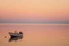 Pink sunrise with small boat in the ocean, Ifaty, Tulear, Madagascar