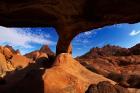 Boy under natural rock arch at Spitzkoppe, Namibia