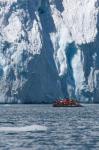 Zodiac with iceberg in the ocean, Antarctica