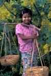 Girl with Painted Face Carrying Basket on Shoulder Pole, Myanmar