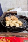 China, Shanghai. Village of Zhujiajiao. Homemade snacks cooked in wok.