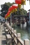 Boat in canal with old wooden bridge, Zhujiajiao, Shanghai, China