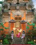 Balinese Dancer Wearing Traditional Garb Near Palace Doors in Ubud, Bali, Indonesia