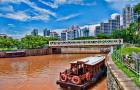 Singapore skyline and tug boats on river.