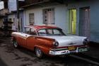 1950's era Ford Fairlane and colorful buildings, Trinidad, Cuba