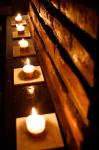 Lighted Candles and Brick Wall