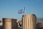Greece, Athens, Acropolis Column ruins and Greek Flag