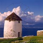 Greece, Mykonos, Windmill looks over Azure Sea
