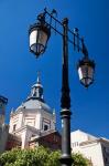 Spain, Madrid Lamppost and the dome of the Las Calatravas Church