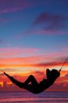 Woman in hammock at sunset, Coral Coast, Viti Levu, Fiji