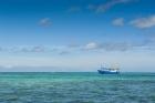 Fishing boat in the turquoise waters of the blue lagoon, Yasawa, Fiji, South Pacific