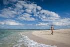 Woman walking on white sand beach of Beachcomber Island, Mamanucas Islands, Fiji