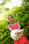 Village boy with large sea shell, Beqa Island, Fiji