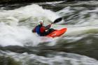 Kayaker plays in a hole in Tariffville Gorge, Farmington River in Tariffville, Connecticut