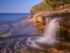 Waterfall Flows Across Sandstone Shore At Miners Beach