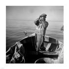 Hauling in a cod aboard a Portuguese fishing dory off Cape Cod, Massachusetts