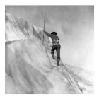 Washington - Mount Rainier Guide cutting steps on ice slope near summit