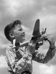 1930s 1940s 1950s  Freckle-Faced Boy Holding Airplane