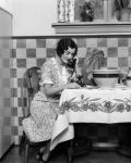 1920s Woman Sitting At Kitchen Table