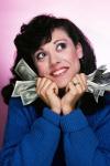 Excited Brunette Woman Holding Several Dollar Bills