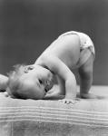 1940s Baby Bending Down With Head On Blanket