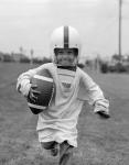 1950s Boy In Oversized Shirt And Helmet