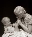 1930s Mother Kissing Bottom Of Baby'S Foot