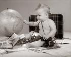 1960s Baby Seated Looking At Globe