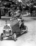 1930s Boy Driving Home In Race Car