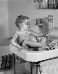 1940s Girl Sitting In Sink Lathered With Soap