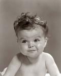 1950s Portrait Baby With Messy Curly Hair & Straight Face