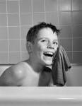 1950s 1960s Boy Washing Face Sitting In Bathtub
