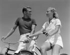 1930s 1940s Smiling Couple On Bikes Looking At One Another