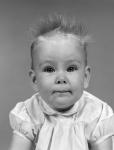 1960s Head On Portrait Of Baby Girl In Ruffled Dress
