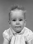 1960s Head On Portrait Of Baby Girl In Ruffled Dress
