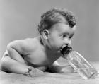 1950s Baby Leaning Forward Drinking From Bottle