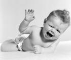 1950s Baby Lying On Stomach Laughing