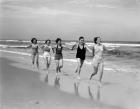 1930s Four Women And One Man Running On Beach