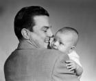 1950s Proud Smiling Father Holding Baby Face To Camera
