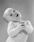 1950s Baby In Diaper Head To One Side Arms Hands Clasped In Front