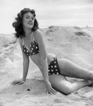 1950s 1960s Brunette Bathing  Stretched Out On Sand?