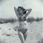 1950s Brunette Beauty In Polka Dot Bikini Standing In Sand