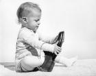 1960s Baby Boy Trying To Put On Man'S Shoe