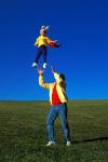 1990S Father Tossing Daughter Up In The Air