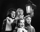 Children Singing Christmas Carols Outdoor By Lantern Light