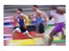 Side profile of three men running on a running track