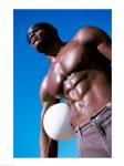 Low angle view of a young man holding a volleyball