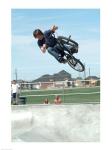 Low angle view of a teenage boy performing a stunt on a bicycle