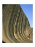 Person climbing Wave Rock, Western Australia, Australia