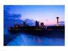 Waterfall with buildings lit up at dusk, American Falls, Niagara Falls, City of Niagara Falls, New York State, USA